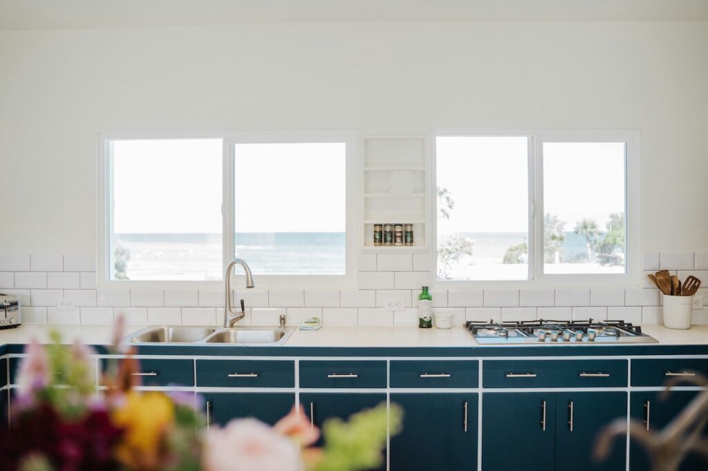 coastal kitchen design ideas - blue cabinets with beach view