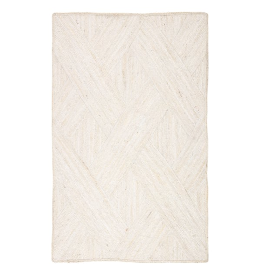 White area rug with herringbone and crossing line pattern