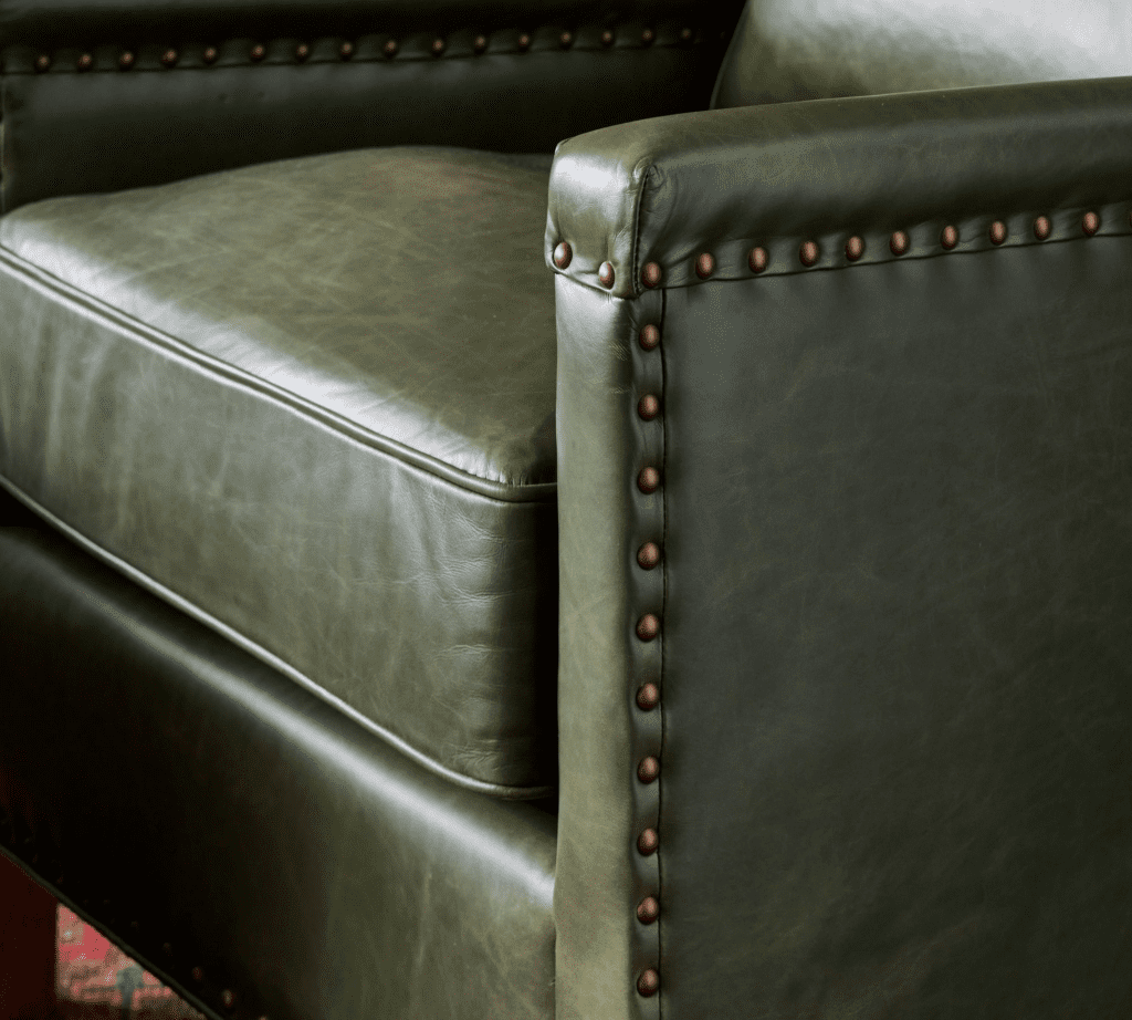 green accent chair with nailhead detail